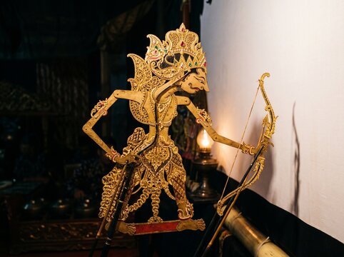Traditional Indonesian Wayang Kulit Shadow Puppet Intricate Gold Detail Dark Background