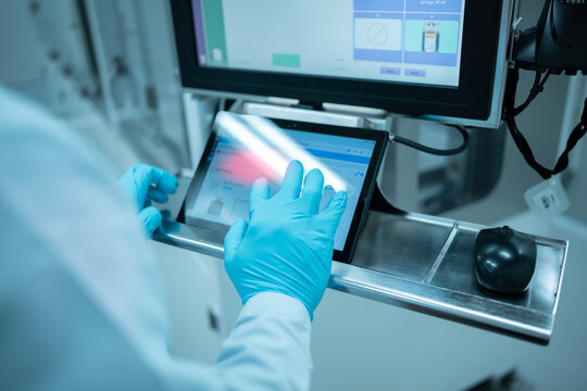Scientist using tablet computer in scientific office.Medical engineers work together on artificial intelligence data and analysis.Technician us computer production at modern automate electronic.