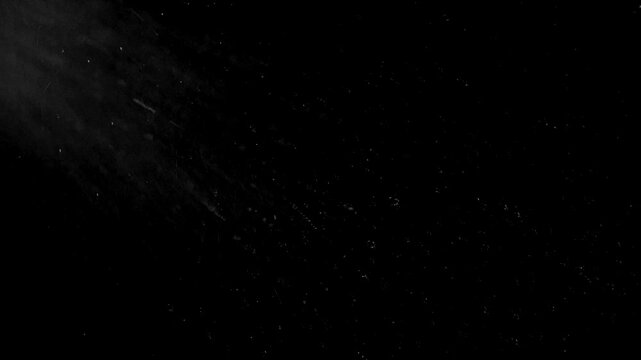 Night rain with tiny drops on a deep black background. 