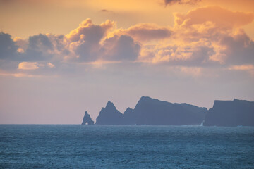 Dramatic Sea Cliffs Silhouette at Sunrise over the Atlantic Ocean Madeira island Portugal seashore landscape © ValentinValkov