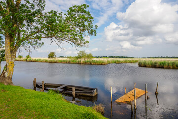 The Rozé Canal with traditional barges in the Brière Nature Park, France © serge