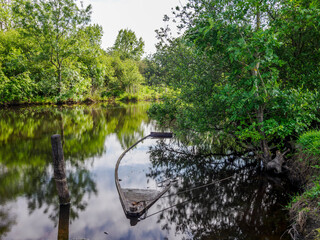 The Rozé Canal with traditional barges in the Brière Nature Park, France © serge