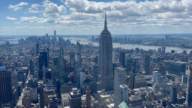 Panoramic view of New York City skyline with Empire State Building under a blue cloudy sky