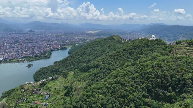 Aerial drone view of Pokhara Nepal with Phewa Lake green hills and cityscape