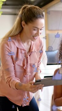 Vertical video: Lead coming to peer, angling tablet, tapping, swiping, icons showing office metrics