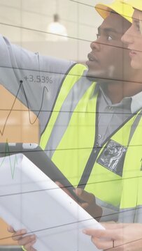 Vertical video: Site team pointing at plans and tablet for construction overlays and hard hat on