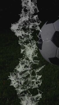 Vertical video: Light mesh forming bottom, rising, shedding nodes, covering soccer ball, scanning