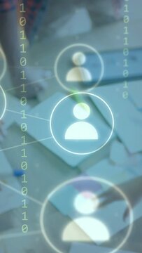 Vertical video: Single icon fading in, team moving notes and using tablet, network forming for work