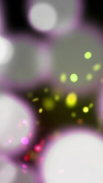 Vertical video: Green spot appearing bokeh growing neon flecks forming and drifting creating scene