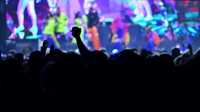 Crowd recording live performance at a vibrant music concert with smartphones