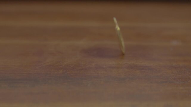 A physical gold Bitcoin coin spinning in slow motion, showcasing cryptocurrency, digital finance, and modern virtual investment concepts.