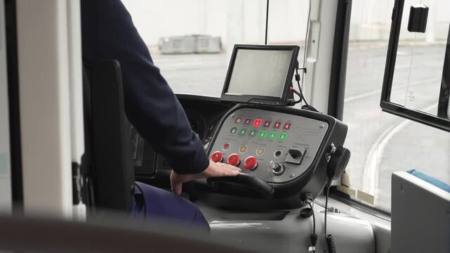 Tram driver's job. The driver controls the car's movement using a dashboard with display and buttons.