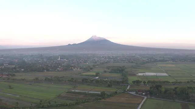 Cinematic Aerial Drone Shot of Mount Merapi Volcano at Sunrise, Indonesia.