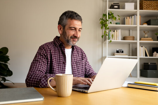 Man working from home office using laptop