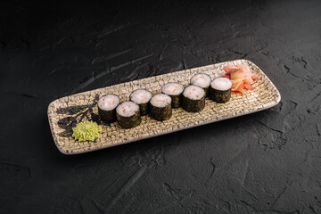 Classic ebi maki sushi rolls with shrimp served on a plate with wasabi and pickled ginger at a restaurant © AntAlexStudio
