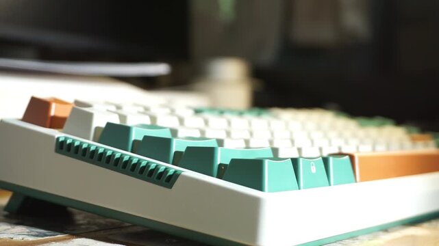 A dynamic top down view of a colourful mechanical keyboard with white, green, and orange keys, spinning and panning rapidly across the board, capturing the keycap layout and smooth