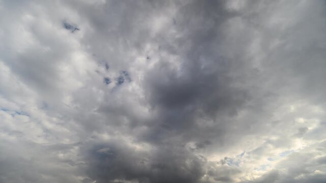 Dark storm brewing. Clouds gathering before rain. Dramatic time lapse of brewing storm clouds. Tense atmosphere with rolling thunder and threatening cloud cover overhead