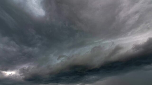Cinematic drone footage of dark, fast-moving storm clouds and a heavy overcast sky over the Florida coastline.