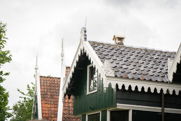 Obraz premium Authentic Zaandam mills on the water channel in Zaanse Schans willage. Zaanse Schans Windmills and famous Netherlands canals, Europe.