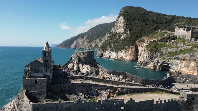 Italy, Liguria, The Church of San Pietro in Portovenere in the province of La Spezia, perched on a rocky spur overlooking the sea, is a Gothic-Genoese jewel from the 13th century - drone view 