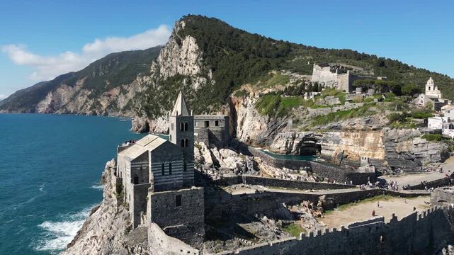 Italy, Liguria, The Church of San Pietro in Portovenere in the province of La Spezia, perched on a rocky spur overlooking the sea, is a Gothic-Genoese jewel from the 13th century - drone view 