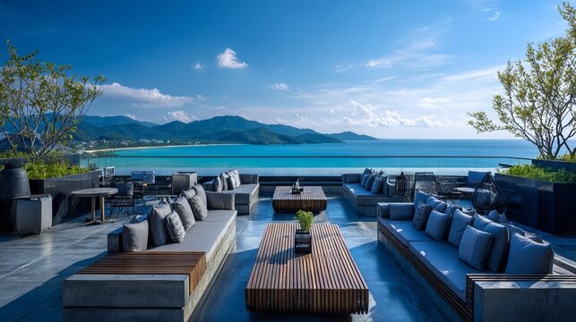 Luxury rooftop terrace at resort hotel in Phuket Thailand with infinity pool, tropical palm trees, ocean view, sunny day