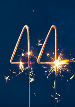 44 years celebration festive background made with Bengal fires in the form of number Forty four. Vertical photography.