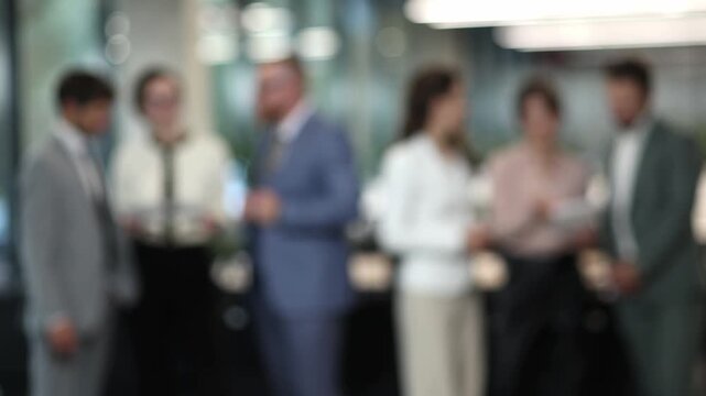 Blurred group of professionals in a modern office setting