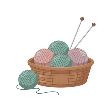 Woven basket with balls of green and pink yarn and knitting needles