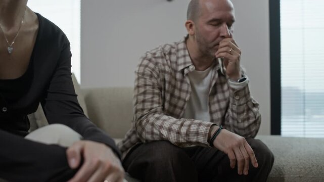 Close up of stressed Caucasian spouses listening to psychologist during family therapy