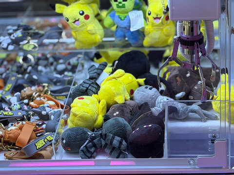 Claw machine with pikachu and creeper plushies