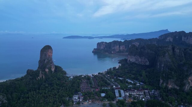 Krabi, Thailand : Aerial drone footage of the famous Railay beach and resort surrounded by karst in coastline of Krabi, Thailand on sunrise. Taken with forward motion