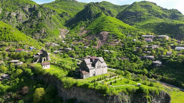 Aerial view of Akhtala Monastery, a medieval fortified Armenian monastery in Lori Province, northern Armenia. Historic Christian complex surrounded by forested hills and mountainous landscape.