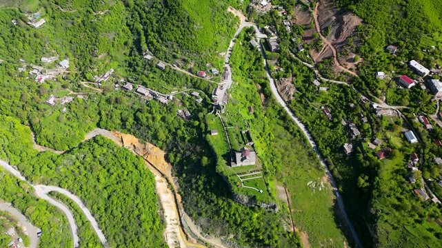 Aerial drone video of Akhtala Monastery and its surrounding landscape in Lori Province, Armenia. Historic medieval monastery complex surrounded by mountains, forests, and rural scenery in Armenia.