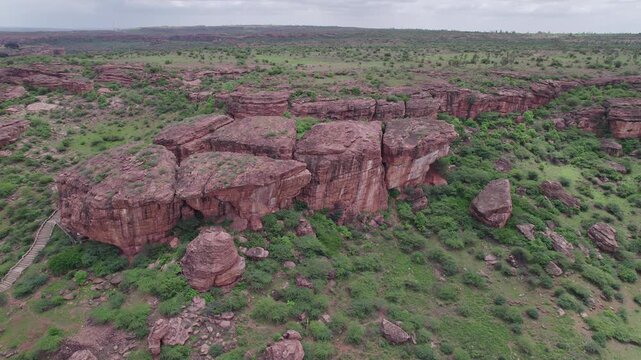 Drone view of Badami Caves and surrounding terrain with rocky landscape