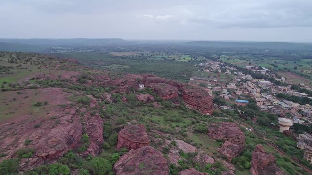 Dolly shot of Badami Caves with surrounding terrain and urban landscape