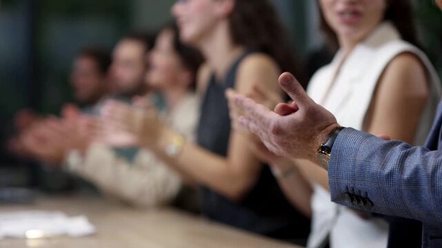 Group applauds warmly in a professional setting