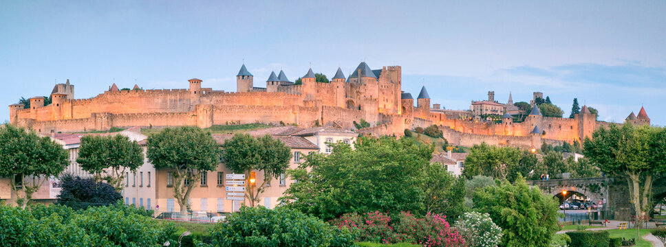 Carcassonne medieval fortified city illuminated at dusk, showcasing historic architecture and a captivating tourism destination in Languedoc-Roussillon, France.