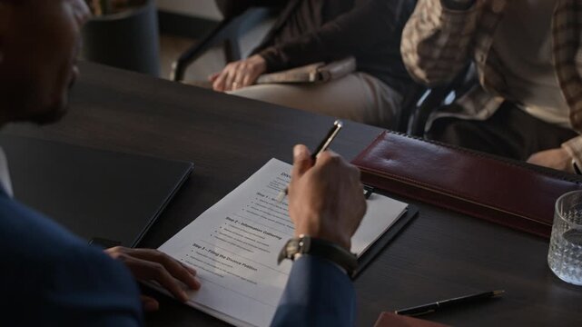 High angle shot of anonymous African American lawyer gesticulating while talking about divorce process overview in office