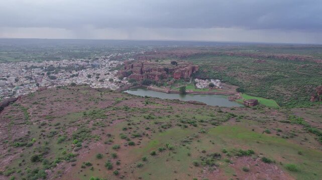 Drone view of Agastya Lake beside Badami Caves with scenic surroundings