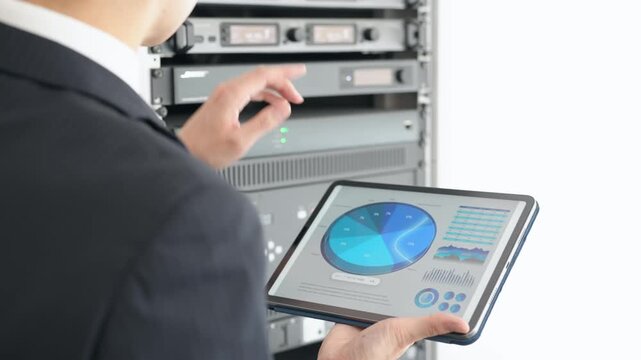 A male engineer inspecting a server.
