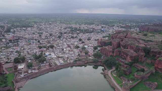 Drone view of Agastya Lake beside Badami Caves with scenic surroundings