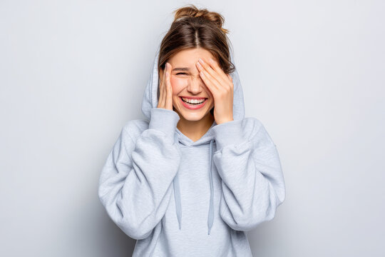 girl in hoodie trembles with tears streaming down her face lost in her emotions