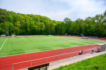 Naklejka premium Modern sports complex with artificial turf soccer field and running track