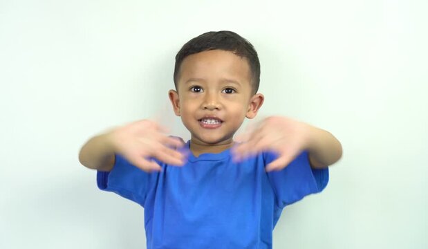 cute and funny little asian boy waving his hands making hand gestures to say good bye saying goodbye, greeting see you next time,
