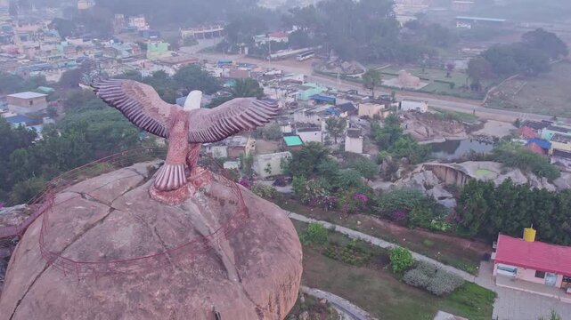 Aerial view of Eagle sculpture or Jatayu Garuda statue with outstretched wings on top of big rock