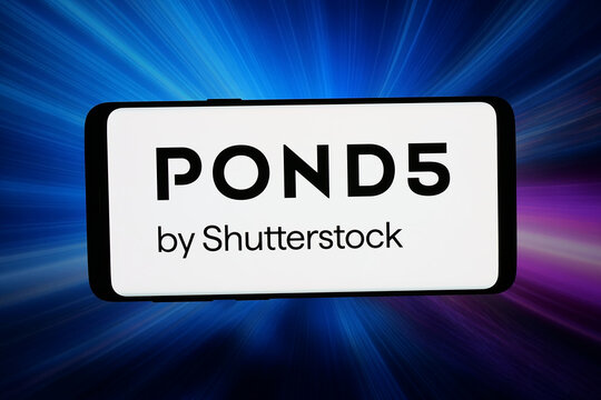 Stuttgart, Germany - 05-08-2026: In this photo illustration, the logo of royalty-free media marketplace Pond5 is displayed on a smartphone in front of abstract background on computer screen.