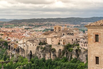 Fototapeta premium Scenic view of Cuenca old town and Hanging Houses perched on dramatic cliffs above the Huecar river gorge in Spain