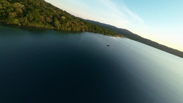 High-energy FPV drone footage follows a Rhinoceros Hornbill (Buceros rhinoceros) as it glides through the sky in Banten