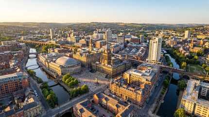 Obraz premium Aerial view of a modern city skyline with a river flowing through it at sunset.